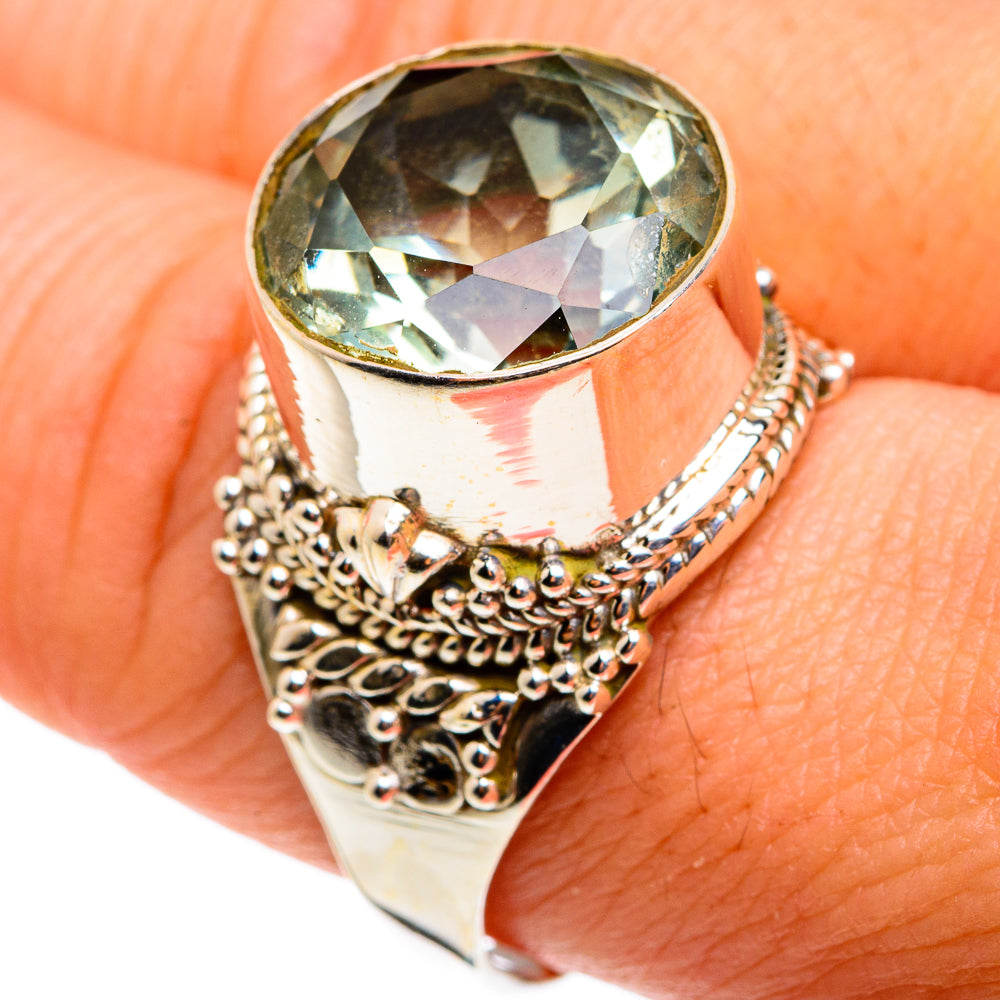 Large faceted green amethyst ring with ornate silver band, close-up stone