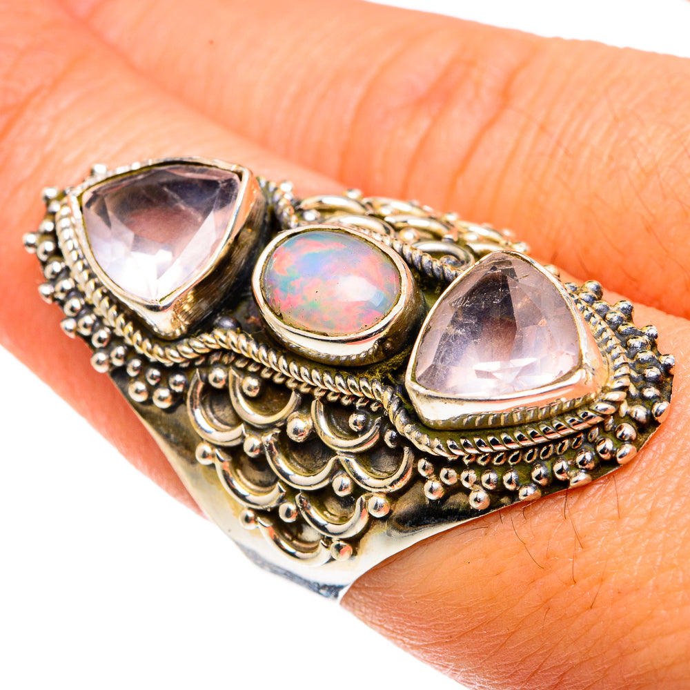 Ornate sterling silver ring with iridescent opal center and two rose quartz teardrops