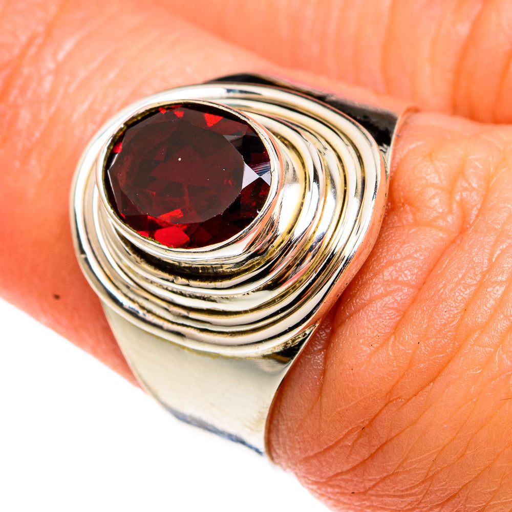 Sterling silver ring with red garnet gemstone in a swirling oval setting