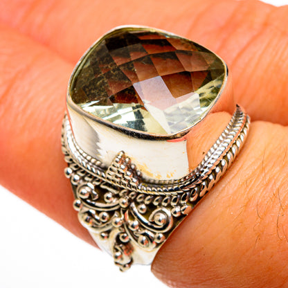 Sterling silver ring with large faceted green gemstone and ornate filigree shoulders