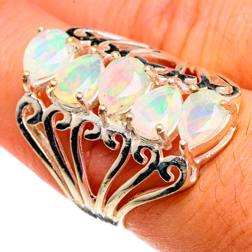 Oval opal faceted sterling silver ring with filigree side design and prong setting