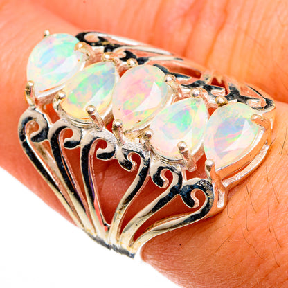 Oval opal faceted sterling silver ring with filigree side design and prong setting