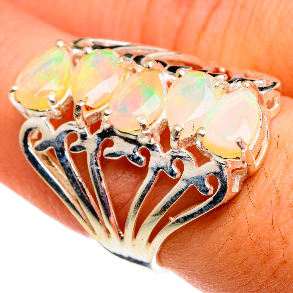 Gold-tone opal ring with three oval faceted Ethiopian opals and ornate openwork band