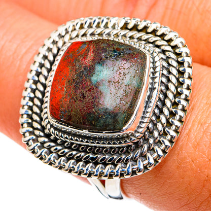 Sterling silver ring with rope-texture border and cushion jasper cabochon, red with blue-teal.