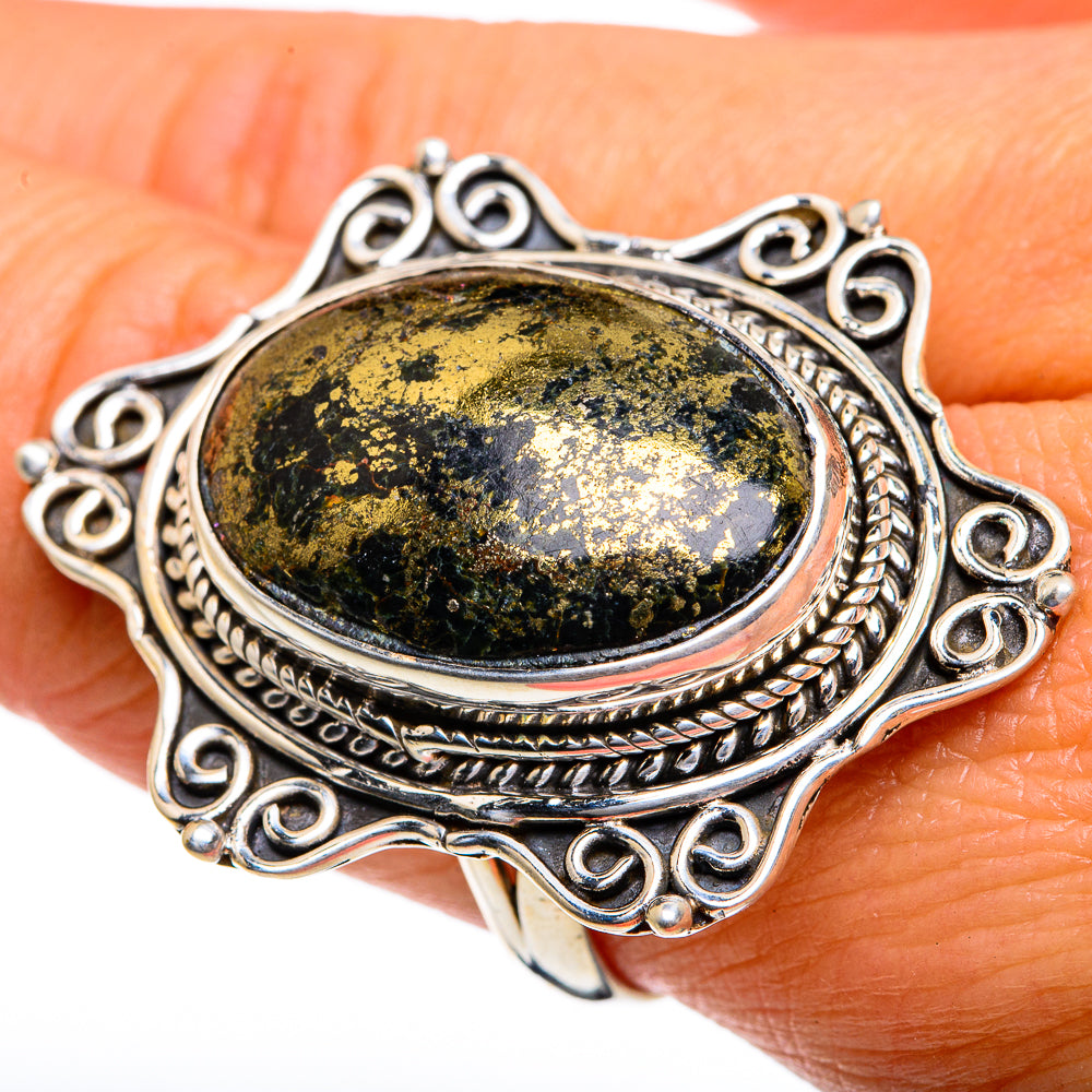 Silver ring with large oval dark green-gold speckled gemstone and ornate filigree setting