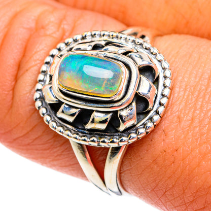 Sterling silver opal ring with oval green-blue gemstone and beaded halo setting