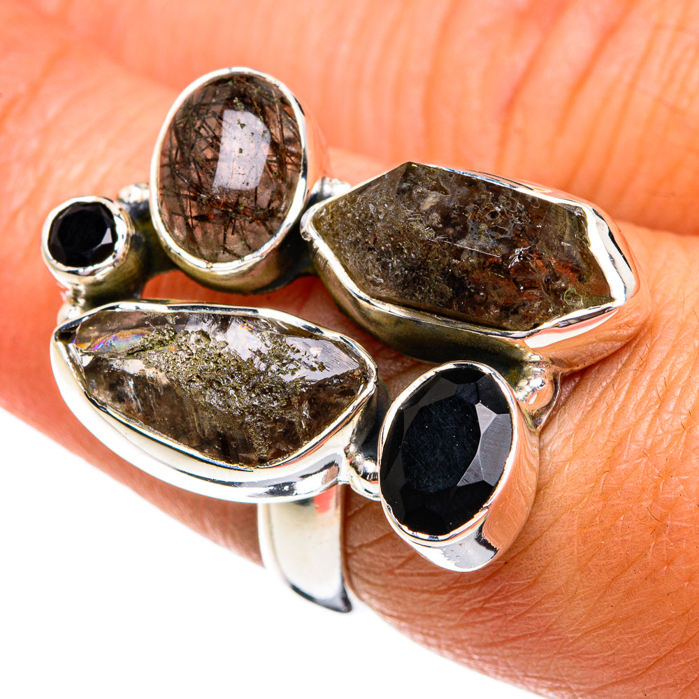 Sterling silver ring with four dark and brown faceted stones in bezel settings