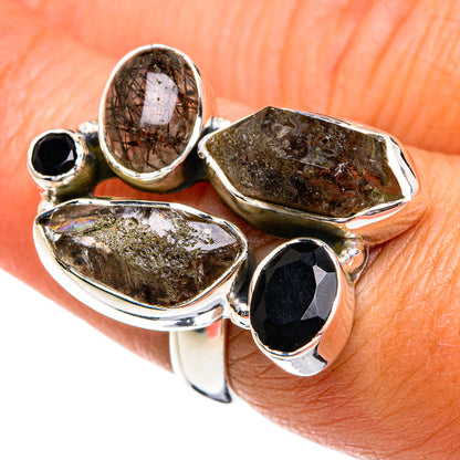 Sterling silver ring with four dark and brown faceted stones in bezel settings