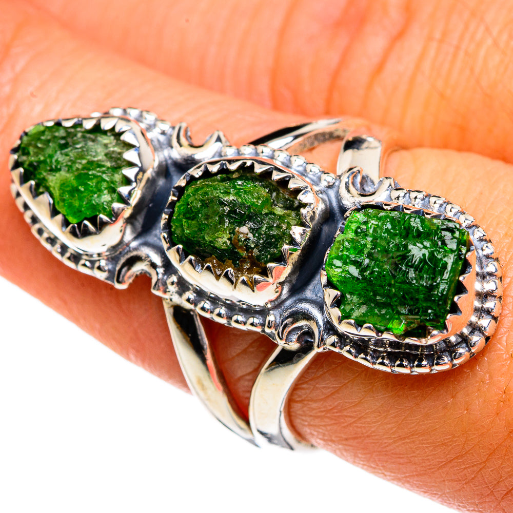 Silver ring with three rough green gemstones in ornate openwork bezels