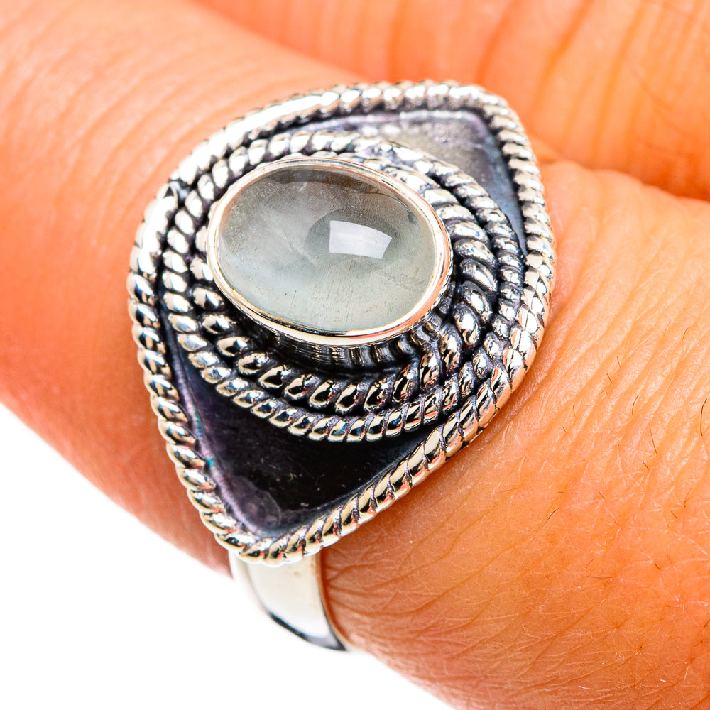 Sterling silver oval aquamarine cabochon ring with ornate rope bezel, dark blue band