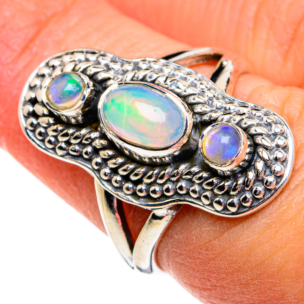 Sterling silver opal ring with large oval center stone and two smaller round stones