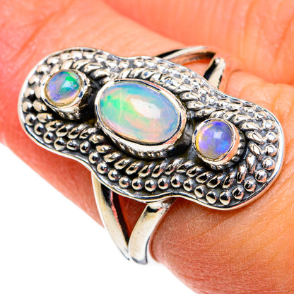 Sterling silver opal ring with large oval center stone and two smaller round stones