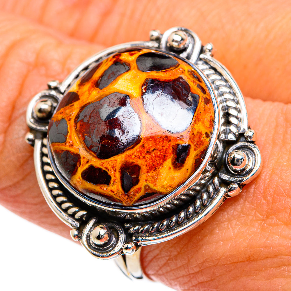 Sterling silver oval ring featuring orange bauxite cabochon with dark mottled areas