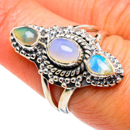 Sterling silver opal ring with three oval gemstones and textured bezel, blue and lilac