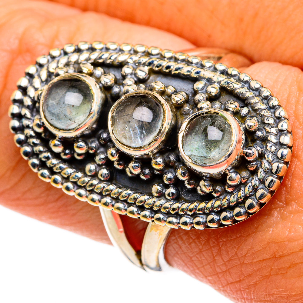 Sterling silver ring with three round aquamarine stones in a textured beaded frame