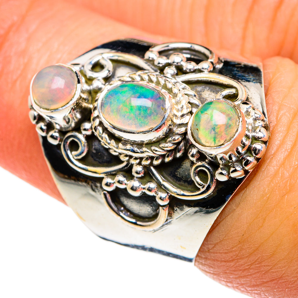 Sterling silver opal ring with oval opals in raised filigree scrollwork