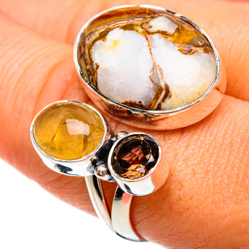 Sterling silver adjustable ring with oval white-and-amber stone, yellow oval, dark round accents