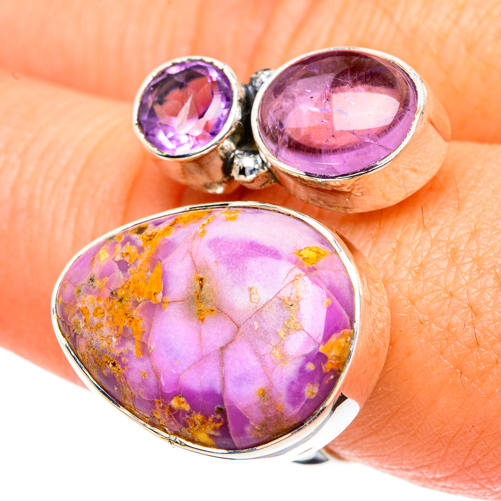 Silver-toned ring with golden-speckled oval purple cabochon and two round purple stones