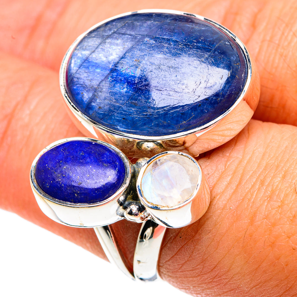 Silver adjustable ring with large oval blue gemstone, small oval blue, and round opalescent stone
