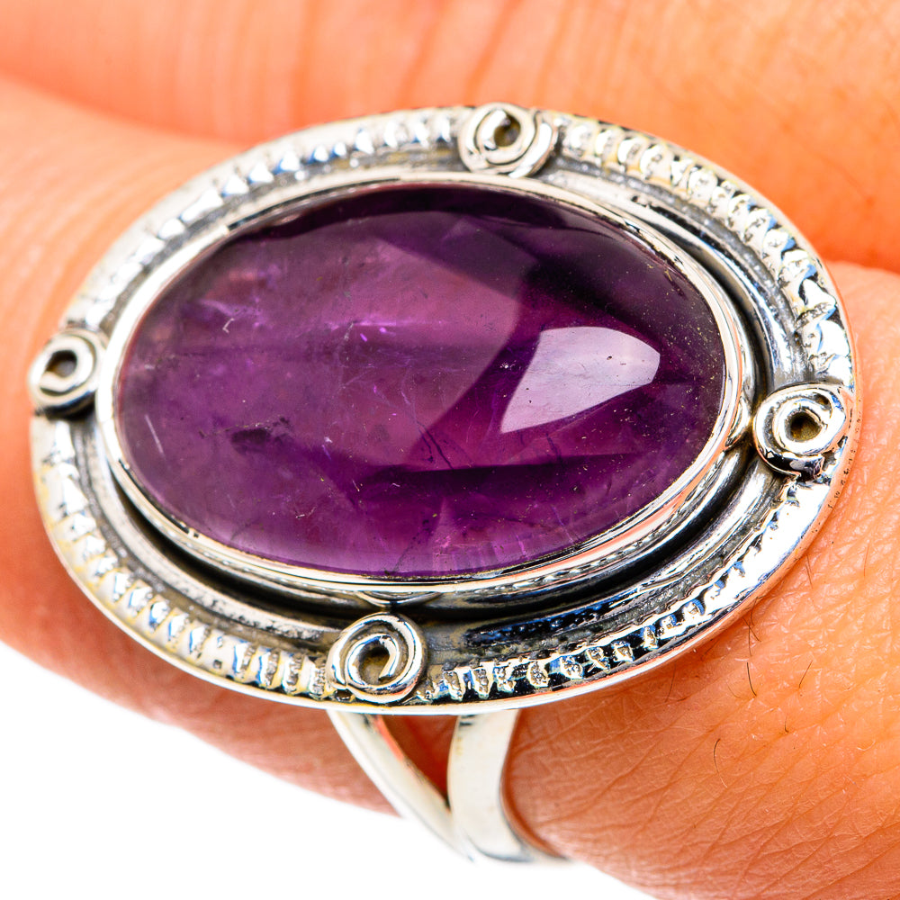 Oval purple amethyst gemstone ring in silver-toned setting with corner details