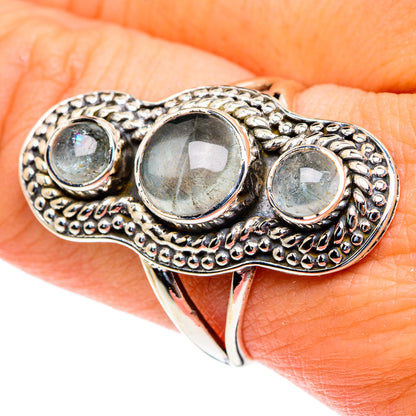 Sterling silver aquamarine ring with three bezel-set round stones, textured oval band
