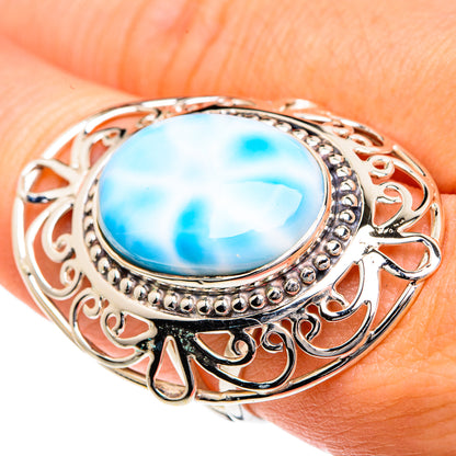 Sterling silver larimar ring close-up with oval blue stone and decorative openwork band