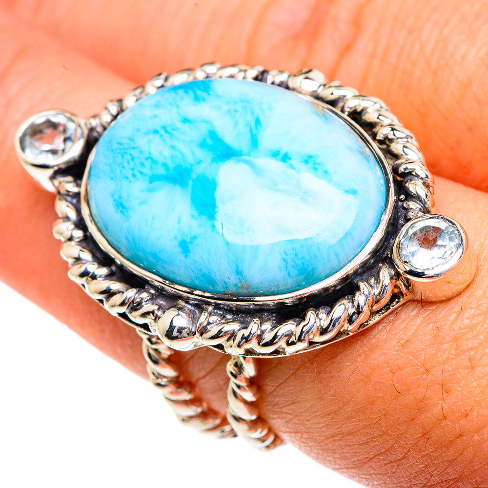 Oval blue gemstone ring on wrist, ornate 925 sterling silver with clear side stones