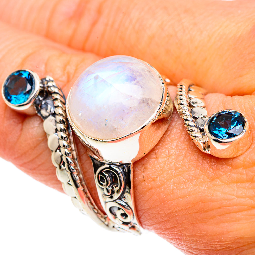 Silver filigree ring with round moonstone and blue side gemstones on hand