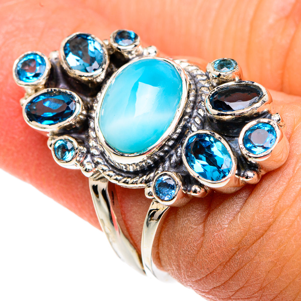 Oval turquoise ring with blue gemstones in ornate sterling silver setting