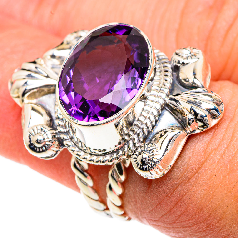 Oval amethyst ring with purple faceted stone and ornate sterling silver band