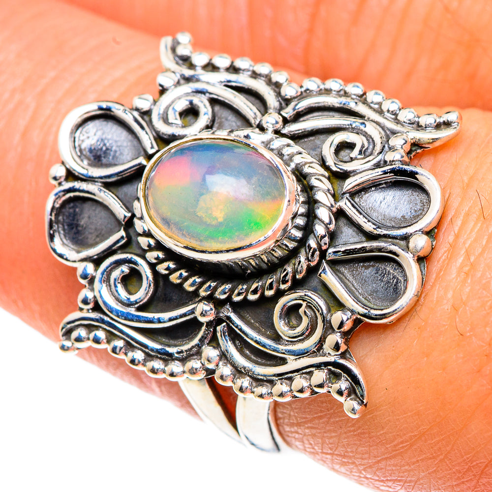 Sterling silver ornate opal ring with round rainbow opal bezel and leaf-like details