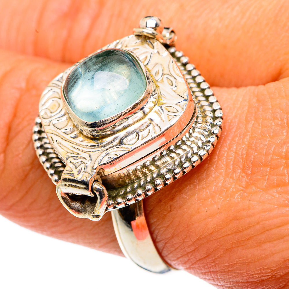 Sterling silver poison ring with oval aquamarine stone, textured edge, open back band