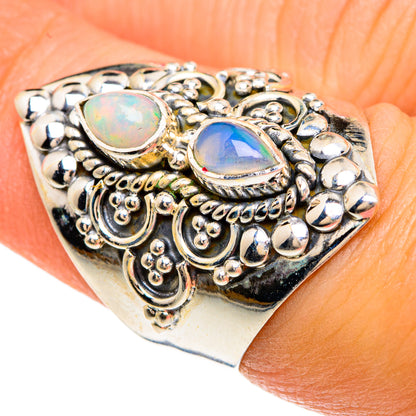 Sterling silver opal ring with two oval Ethiopian opal cabochons and ornate filigree