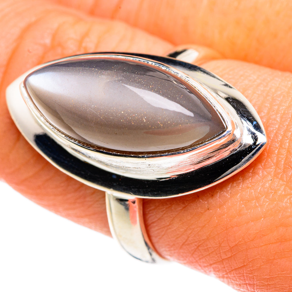 Oval moonstone ring with polished 925 sterling silver bezel on finger