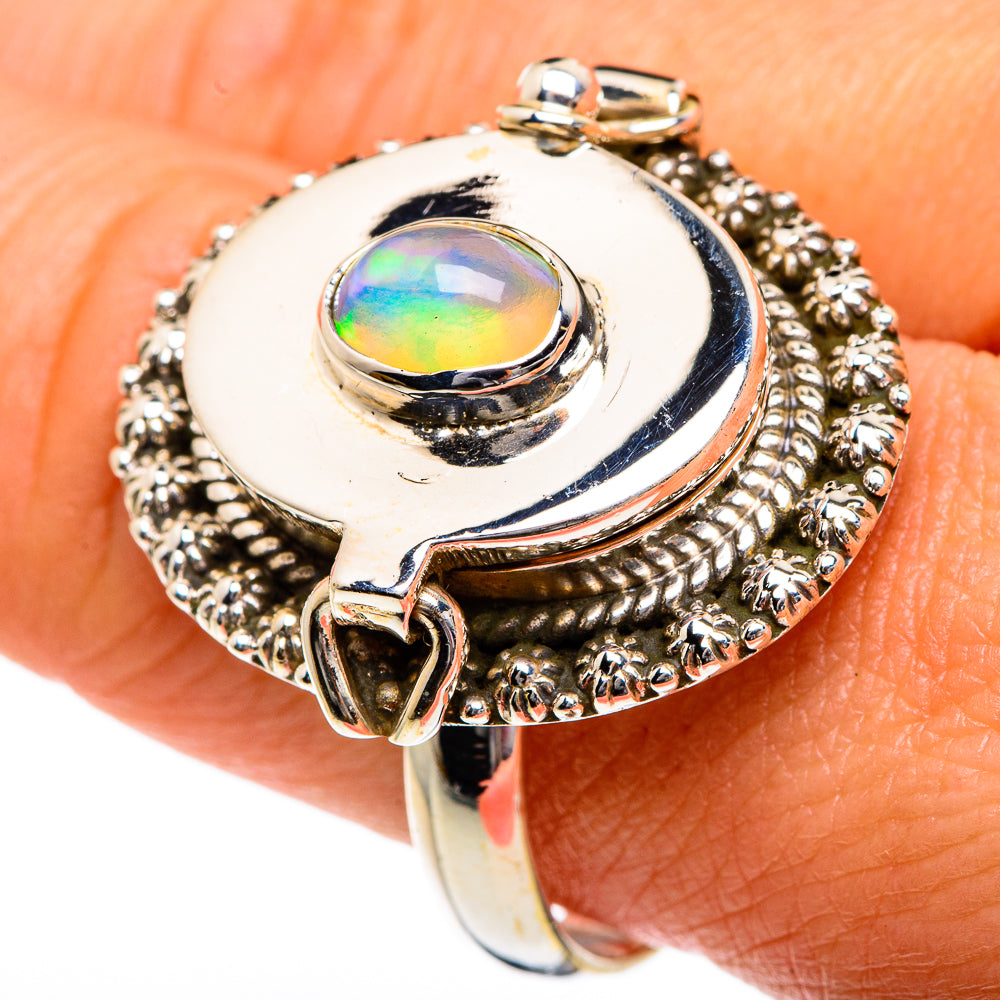 Oval opal ring with textured round halo, silver-tone band and decorative prongs