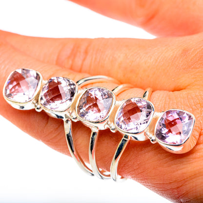 Sterling silver ring with seven faceted pink gemstones along the curved band