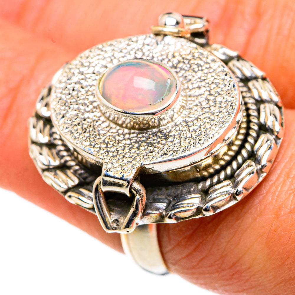 Sterling silver opal ring with round iridescent cabochon and decorative side setting