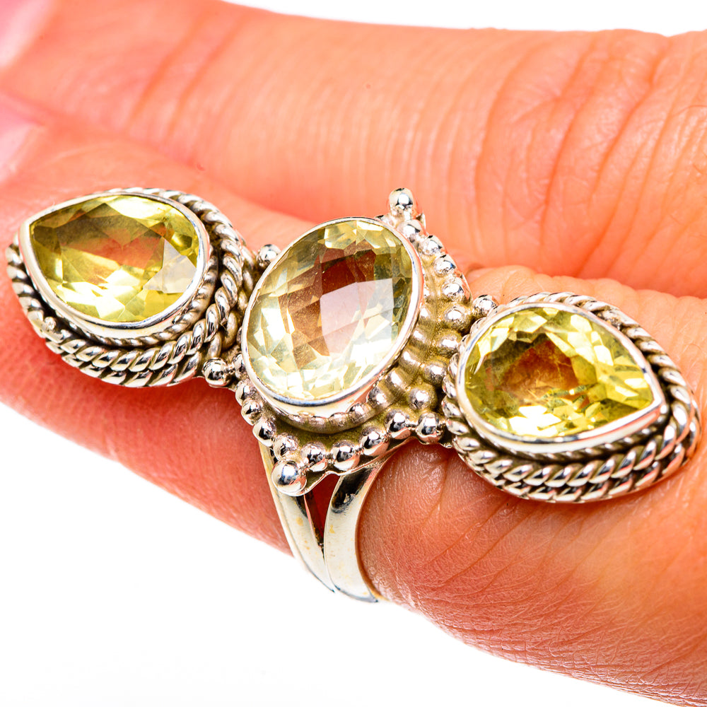 Citrine ring on finger with three oval faceted stones in braided sterling silver bezels