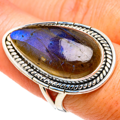 Sterling silver labradorite oval ring with blue-violet flash over golden stone
