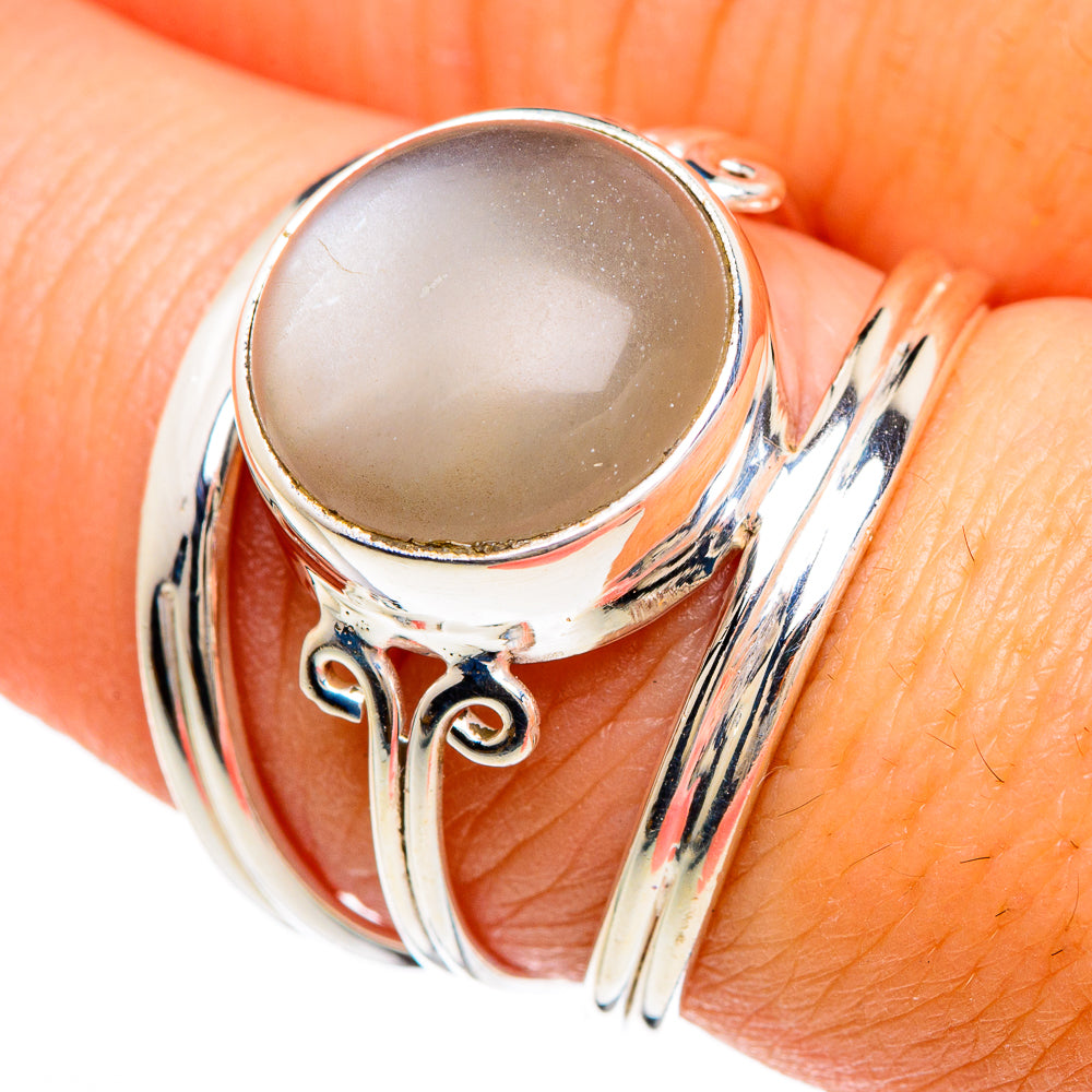 Sterling silver moonstone ring with round pale cabochon and curled side accents