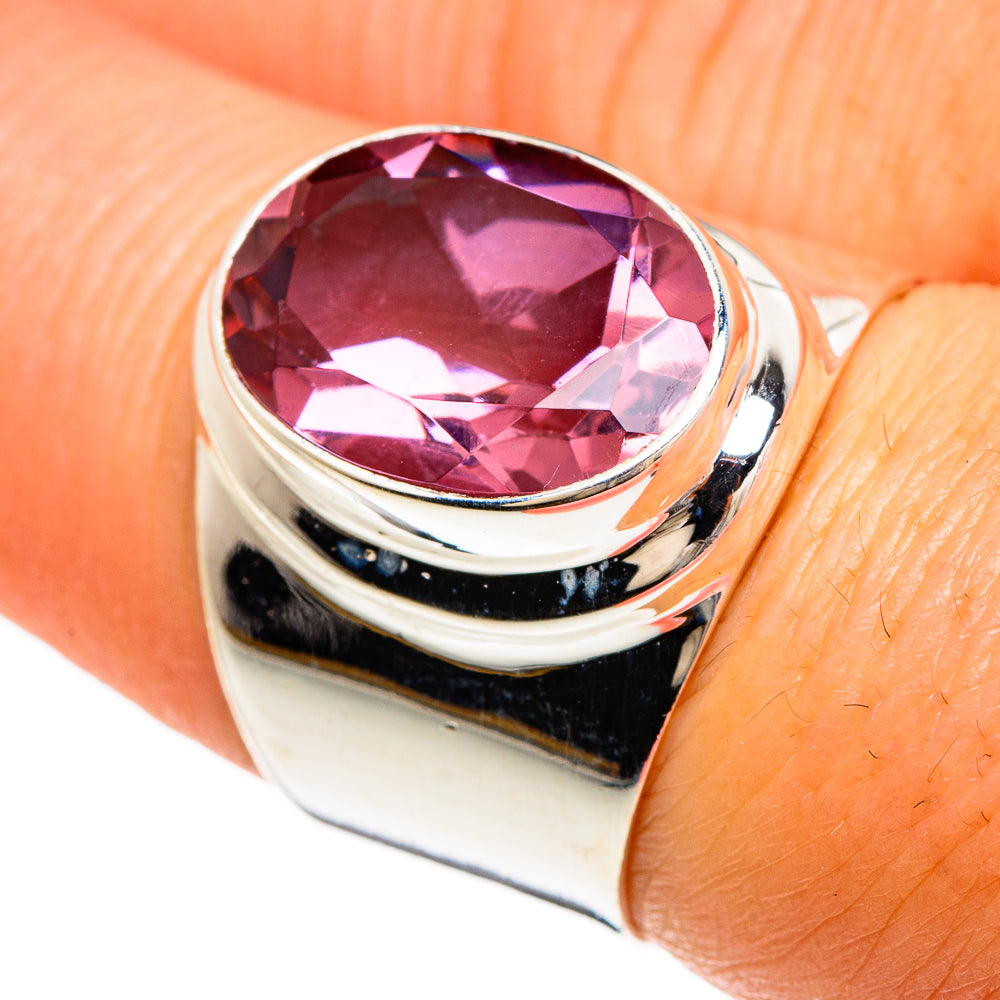 Sterling silver ring with oval purple faceted gemstone, polished bezel