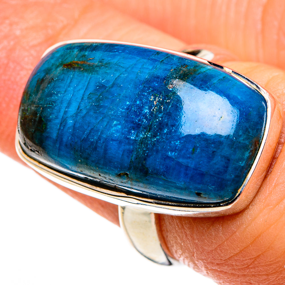 Apatite ring with oval blue cabochon and silver bezel, dark inclusions visible