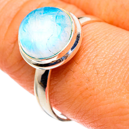 Sterling silver ring with oval moonstone cabochon showing blue sheen.