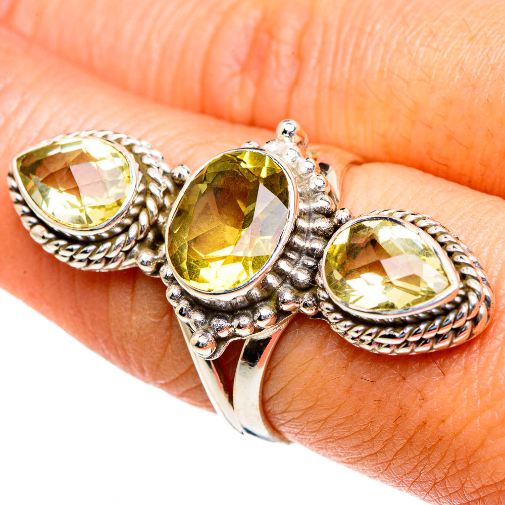 Sterling silver ring with three faceted oval yellow citrine stones on an open braid band