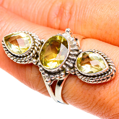 Sterling silver ring with three faceted oval yellow citrine stones on an open braid band