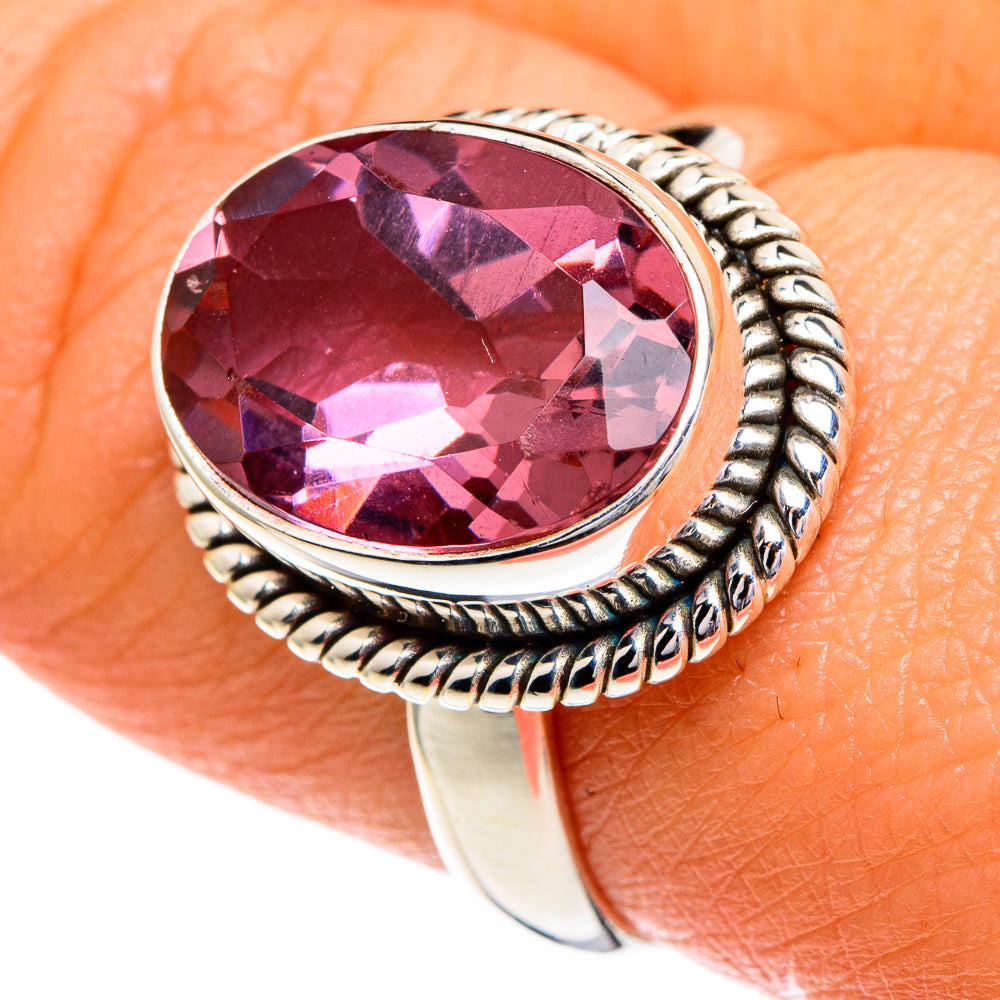 Silver ring with oval color-changing gemstone and twisted rope bezel, pink-purple stone.
