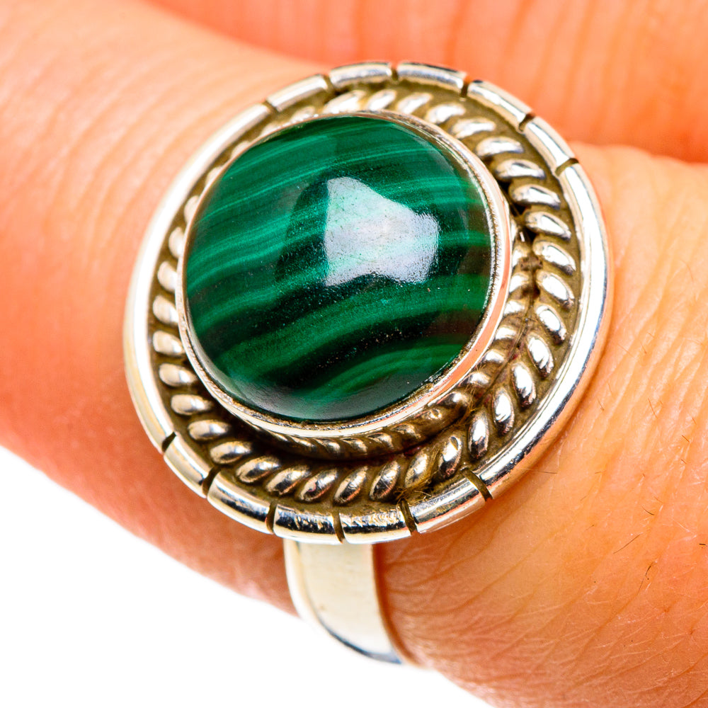 Malachite cabochon ring with oval green stone and ornate metal bezel