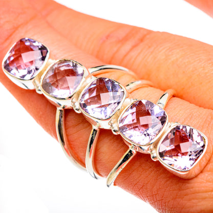 Faceted kunzite ring with oval pink-purple stones and silver-tone prong setting