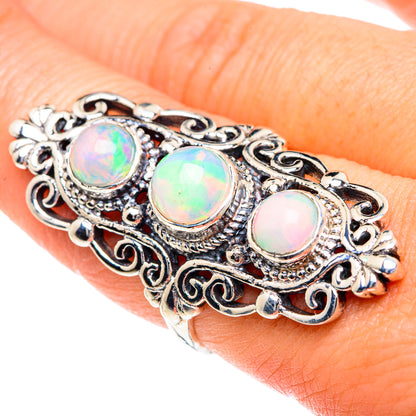 Sterling silver opal ring with three oval cabochons and ornate filigree settings