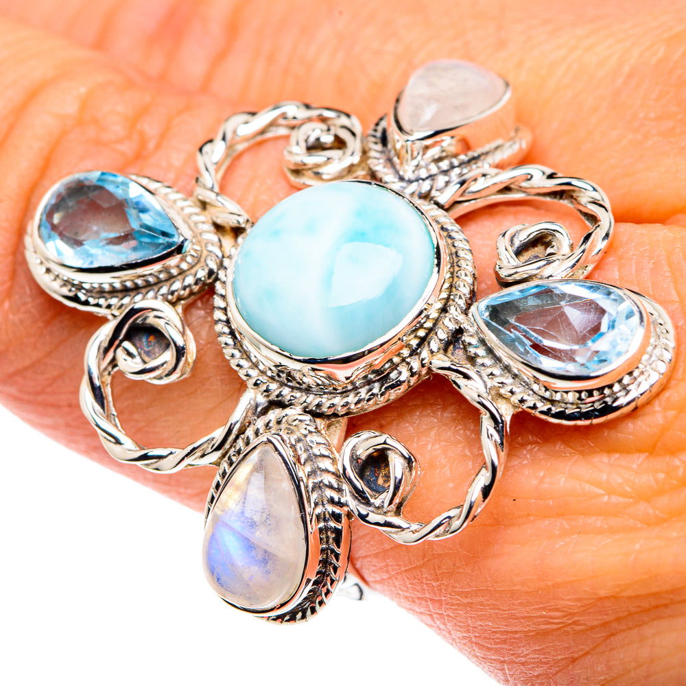 Sterling silver ring with oval larimar center and blue topaz accents, rope filigree